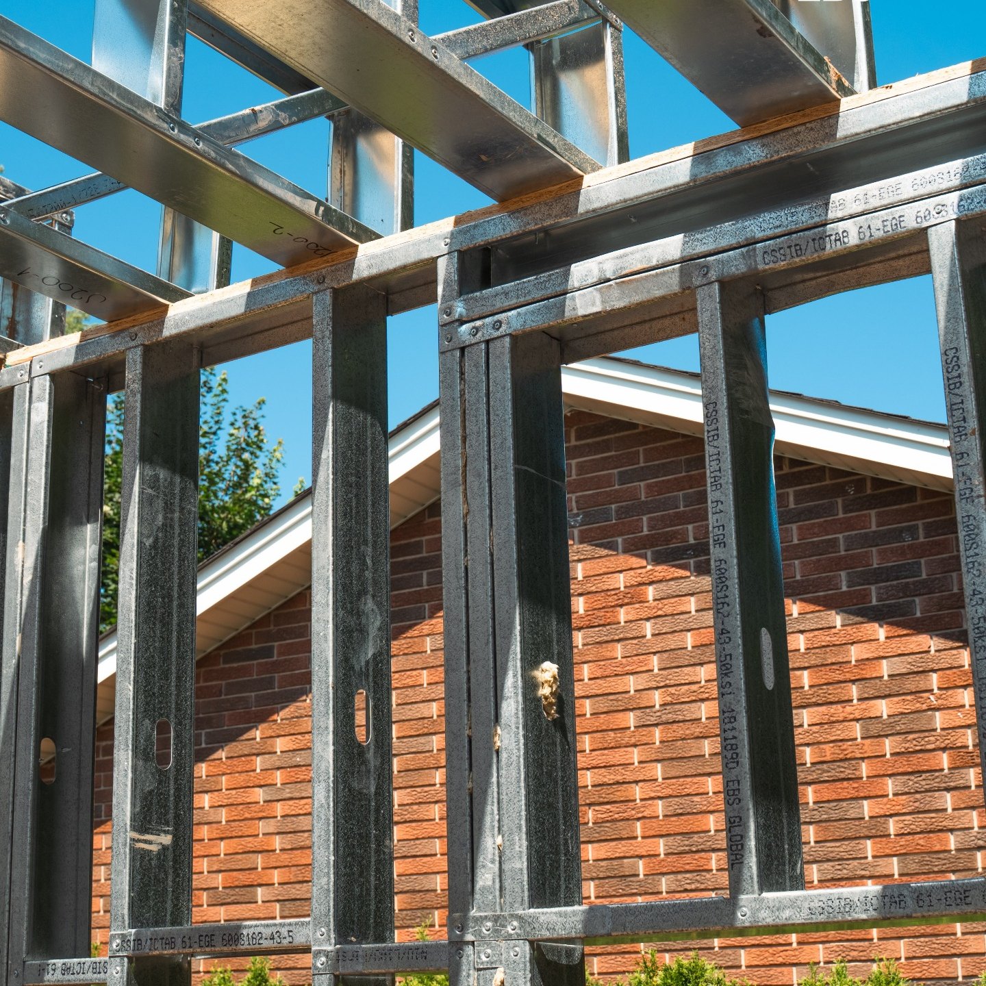 Framing rising beside the existing house.