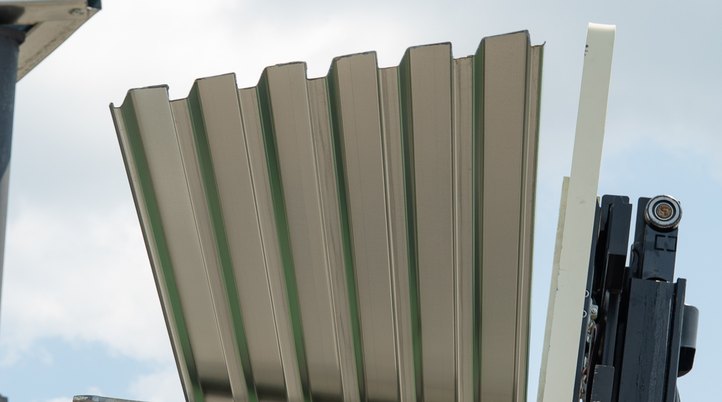 A bundle of steel roof deck lifted by forklift