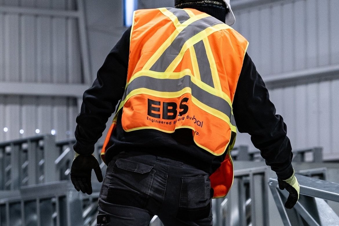 EBS Global worker in a hi-vis vest on the plant floor