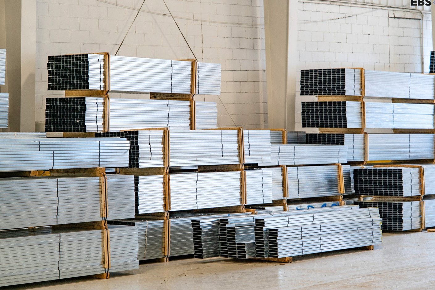 Bundles of galvanized studs and track stacked in the EBS warehouse