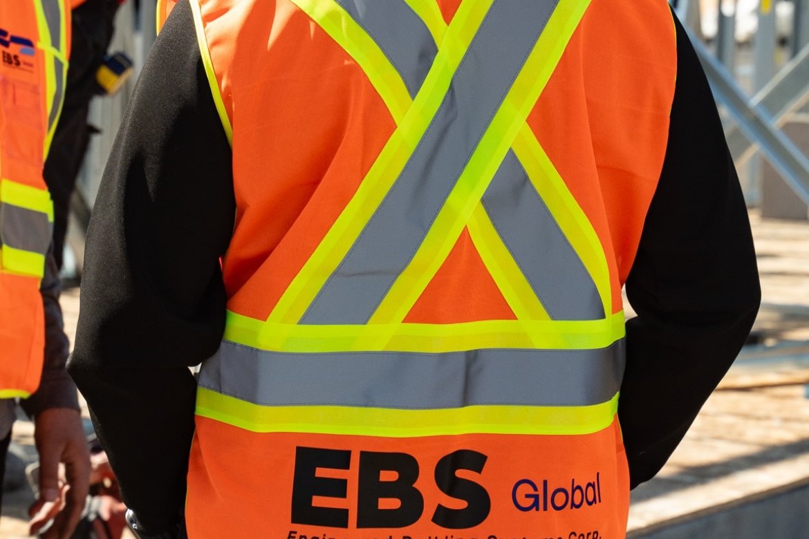EBS Global worker in a branded hi-vis vest on site
