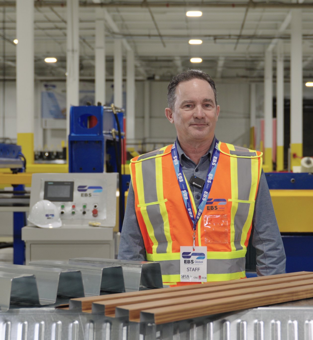 EBS Global staff member in a hi-vis vest on the plant floor in Barrie