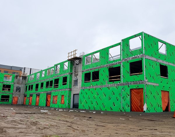 Three-storey cold-formed steel building sheathed in green board, London, Ontario