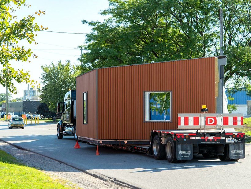 Classroom module leaving the plant on a lowboy trailer