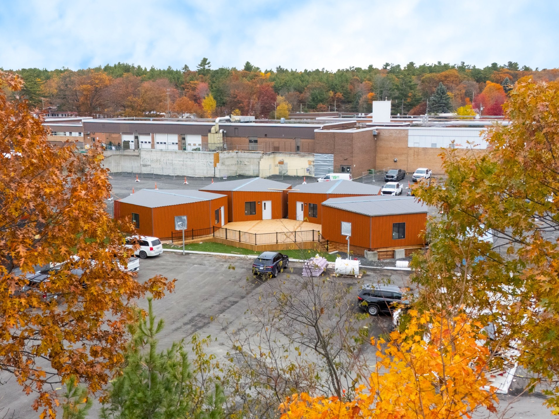 Modular classroom units clad in orange corrugated steel at Parry Sound High School in autumn